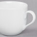 A 10 Strawberry Street white porcelain espresso cup with a saucer.