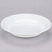 A 10 Strawberry Street Classic White porcelain soup bowl on a gray surface.