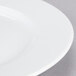 A close up of a 10 Strawberry Street Classic White porcelain dinner plate with a white rim.