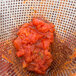 A Vollrath Coarse China Cap Strainer filled with tomato sauce.