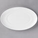 A 10 Strawberry Street Ricard white oval porcelain salad plate on a gray surface.