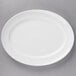 A white oval porcelain platter with a white rim.