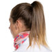 A woman with a ponytail wearing a pink and blue Headsweats Mojave Ultra Band headband.