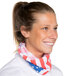 A woman wearing a Headsweats American Flag Ultra Band as a neck scarf and smiling.