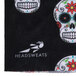 A black fabric with white skulls and flowers.