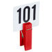 An American Metalcraft red wooden clothespin card holder clipped to a white card with black numbers.
