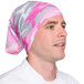 A man wearing a pink and white camouflage Headsweats headband.