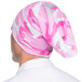 A person wearing a pink and white camouflage Headsweats headband.