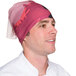 A man wearing a Headsweats Bigfoot Ultra Band headband with a red and pink Bigfoot pattern.