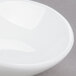 An Arcoroc oval porcelain bowl with a small hole in the middle.