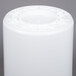 A white cylinder with a round top and a lid.
