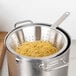 A pot of spaghetti in a Vollrath stainless steel strainer.