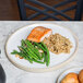 A Chef & Sommelier Geode dinner plate with salmon, green beans, and rice on a table.