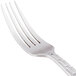 A 10 Strawberry Street Panther Link stainless steel dinner fork with a white handle and silver metal.