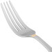 A close-up of a 10 Strawberry Street Parisian gold stainless steel salad fork with a white background.