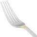 A 10 Strawberry Street stainless steel dinner fork with a gold stripe on the handle.