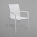 A close-up of a white Grosfillex Sunset arm chair with armrests.