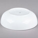 A CAC Bright White Porcelain Salad Bowl on a gray surface.