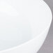 A CAC bright white porcelain salad bowl with a white rim.