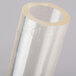 A clear plastic tube with a circular cut on a white background.