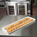 A white MFG Tray supreme display tray of cookies on a bakery counter.