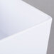 A close-up of a white Tablecraft melamine rectangular bowl.