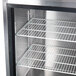 A Continental Refrigerator stainless steel back bar refrigerator with sliding glass doors and shelves.