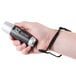 A hand holding a black and silver Dri Mark UV Pro counterfeit detector light.