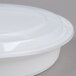A white plastic 48 oz. microwavable container with a lid.