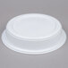 A white plastic bowl with a lid on a gray surface.