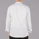 The back of a white Mercer Culinary chef jacket with black piping.