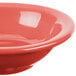 A Libbey porcelain fruit bowl with a red rim.