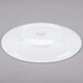 A Libbey Aluma White porcelain coupe plate with a circular rim on a gray surface.