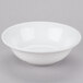 A white Libbey aluma porcelain bowl with a white rim on a gray surface.