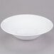 A Libbey white porcelain serving bowl on a gray surface.