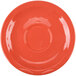 A white Libbey Cantina saucer with a circle pattern on a red background.