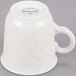 A white porcelain tall tea cup with a handle.