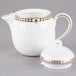 A white Syracuse China Baroque bone china teapot with gold trim.