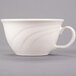 A close up of a Libbey ivory porcelain tea cup with a wavy design and handle.
