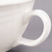 A close up of a Libbey ivory porcelain tea cup with a handle.