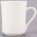 A close-up of a Libbey ivory porcelain mug with a curved handle.