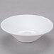 A Libbey white porcelain fruit bowl with a small rim on a white surface.