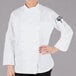 A woman wearing a white Mercer Culinary executive chef jacket.