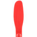 A red plastic paddle with a handle.