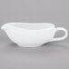 A white Libbey porcelain sauce boat on a gray surface.