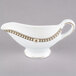 A white and gold Syracuse China sauce boat.