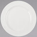 A Libbey ivory porcelain plate with a white rim on a gray background.