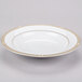 A white Syracuse China bone china soup bowl with gold trim on the rim.