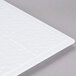 A white melamine plate adapter with a textured surface.