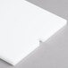 A white rectangular Vollrath ServeWell cutting board.